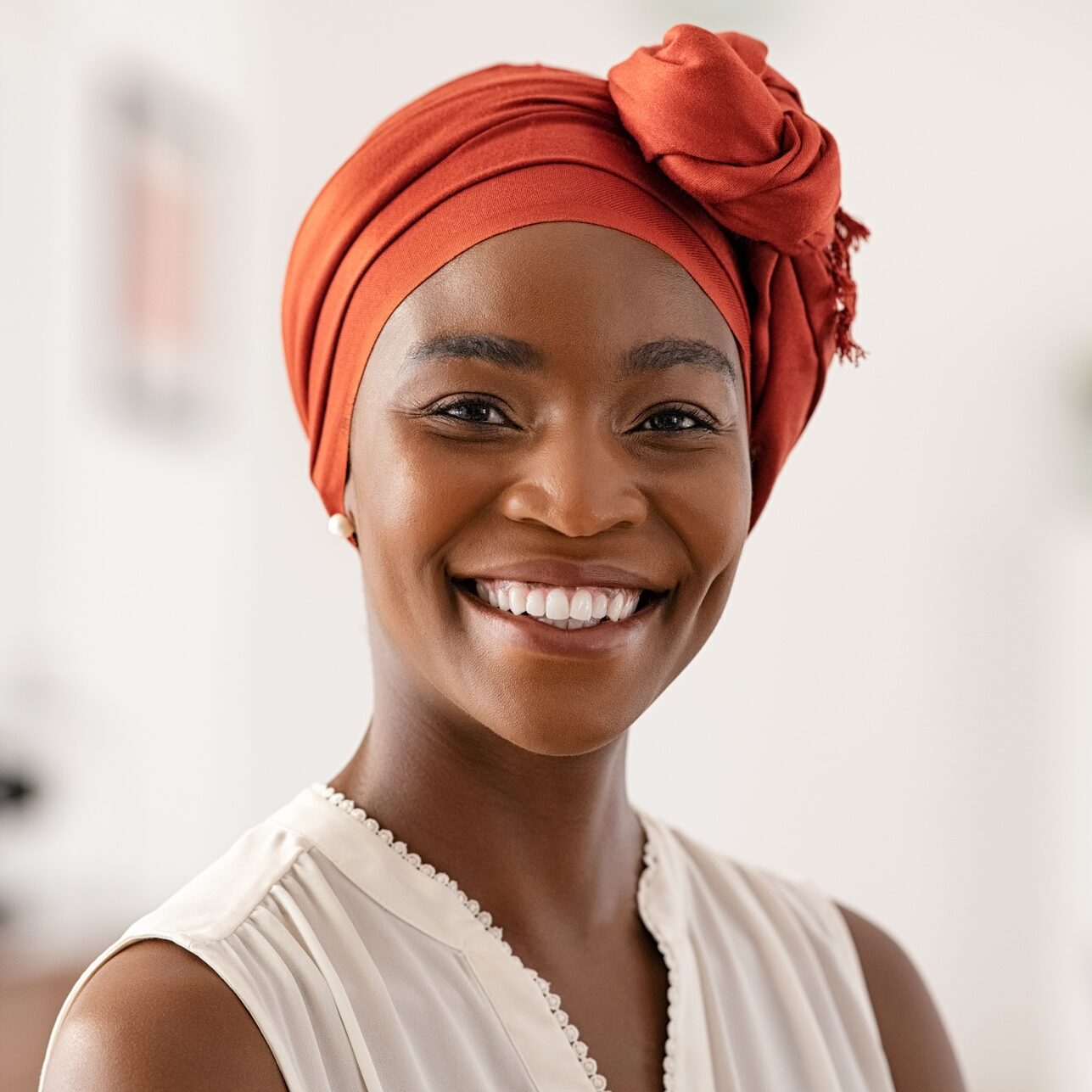 Smiling mature black woman with african headscarf